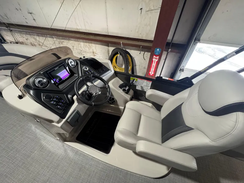 Slide: The Image of 2025 Sylvan L3 DLZ boat interior with modern dashboard and comfortable seating. - 5