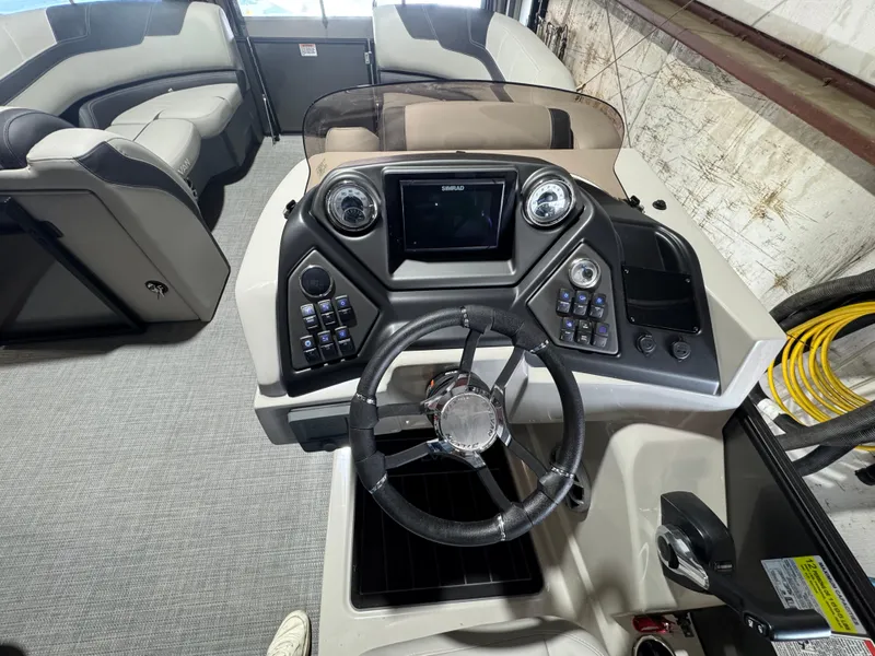 Slide: The Image of 2025 Sylvan L3 DLZ boat interior with modern steering console and seating. - 6