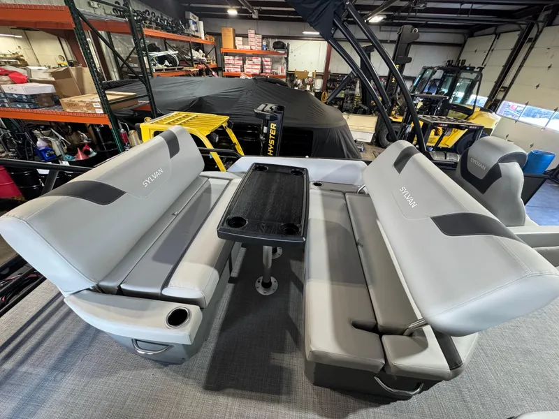 Slide: The Image of 2025 Sylvan L3 DLZ pontoon boat interior with gray seating and a central table. - 8