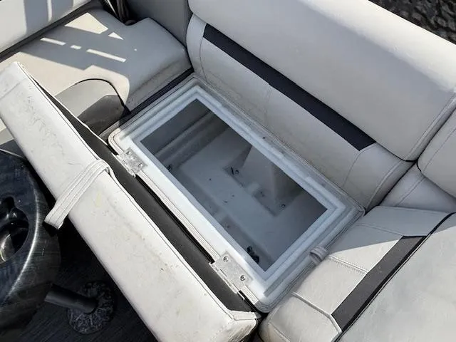 Slide: The Image of Open storage compartment in 2022 Sweetwater 2286 boat with cushioned seating. - 20