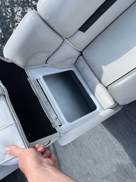Slide: The Image of Open storage compartment in 2022 Sweetwater 2286 boat seat, showcasing spacious interior. - 22