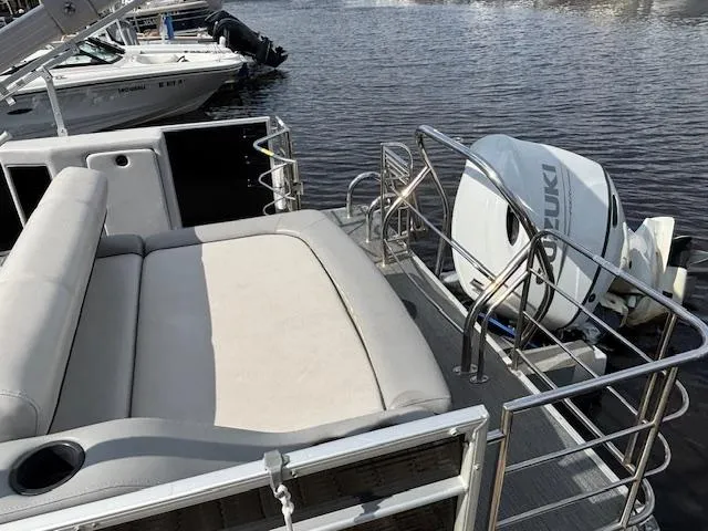 Slide: The Image of 2022 Sweetwater 2286 boat with Suzuki outboard motor, featuring spacious seating and railing. - 8