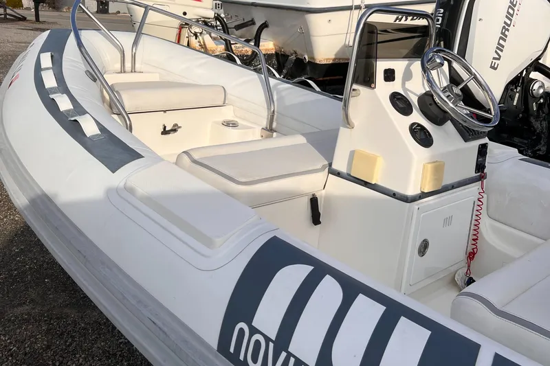Slide: The Image of 2020 Novurania DL 400 boat with steering console and seating, displayed outdoors. - 3