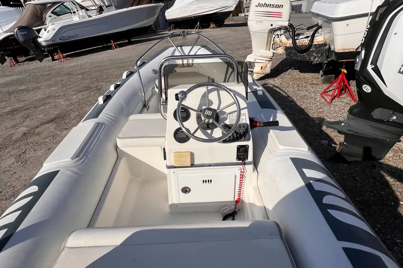 Slide: The Image of 2020 Novurania DL 400 inflatable boat with steering console, parked on gravel. - 4