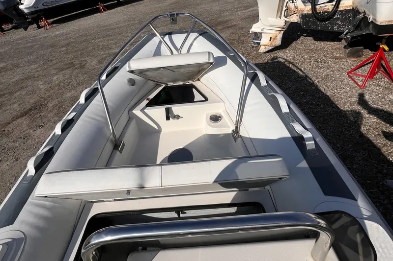 Slide: The Image of 2020 Novurania DL 400 boat interior with seating and storage, displayed outdoors. - 6