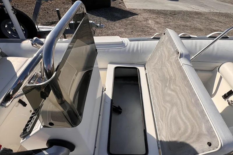 Slide: The Image of 2020 Novurania DL 400 boat interior with open storage compartment and steering console. - 8