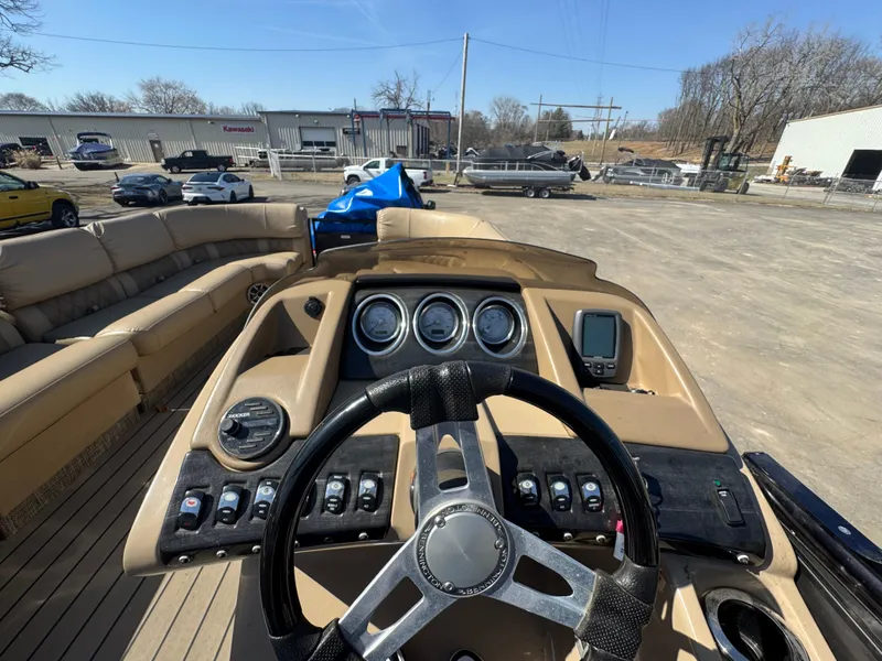 Slide: The Image of 2016 Bennington 2275 RCW boat dashboard with steering wheel and control panel. - 13