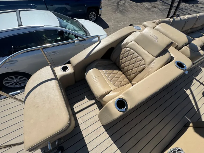 Slide: The Image of Luxurious seating on 2016 Bennington 2275 RCW boat with beige upholstery and cup holders. - 17
