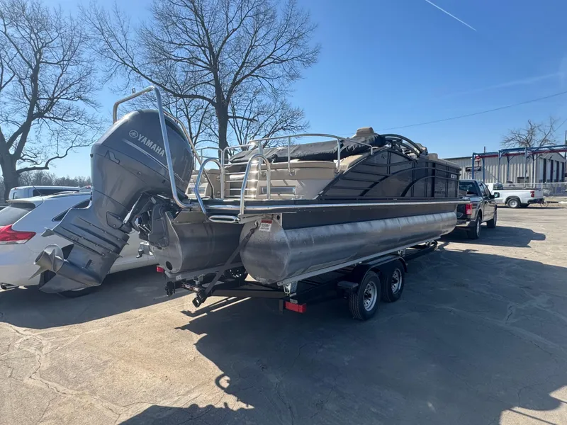 Slide: The Image of 2016 Bennington 2275 RCW pontoon boat on trailer, parked outdoors, with Yamaha outboard motor. - 19