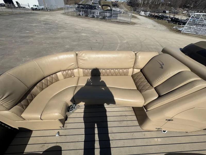 Slide: The Image of 2016 Bennington 2275 RCW boat with beige leather seating and shadow on deck. - 6