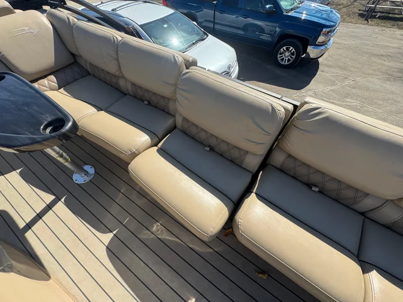 Slide: The Image of 2016 Bennington 2275 RCW boat with beige seating and wooden deck. - 9