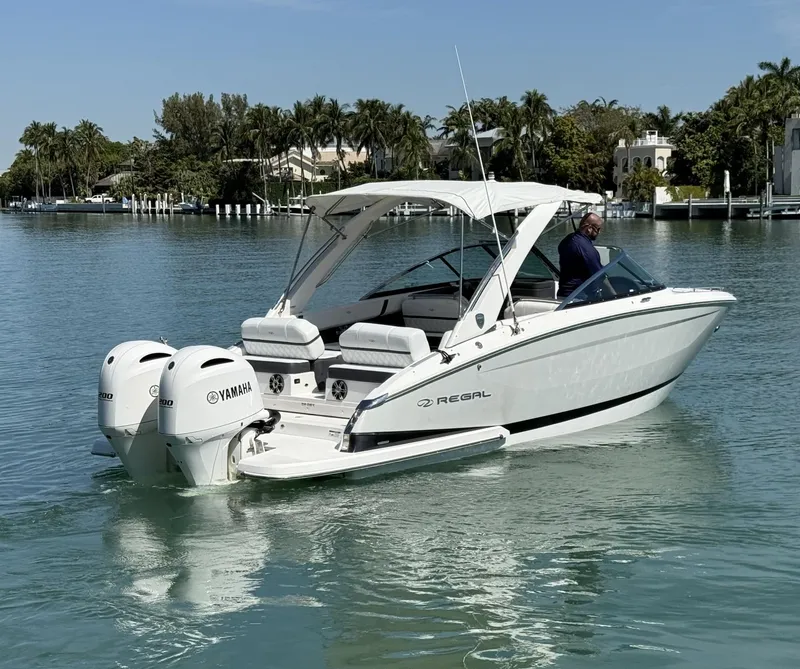 Slide: The Image of 2019 Regal 29 OBX boat with Yamaha engines on a calm waterway. - 11