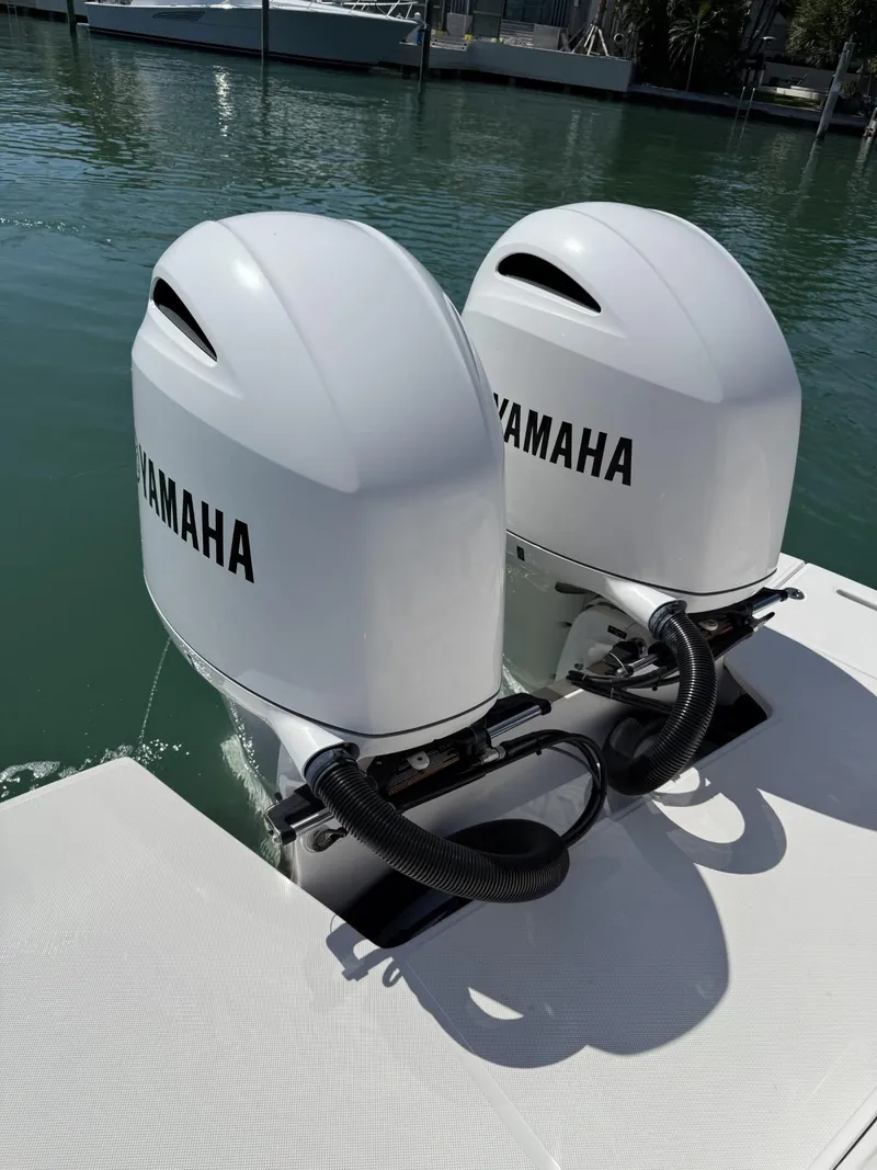 Slide: The Image of 2019 Regal 29 OBX boat with twin Yamaha outboard engines on water. - 13