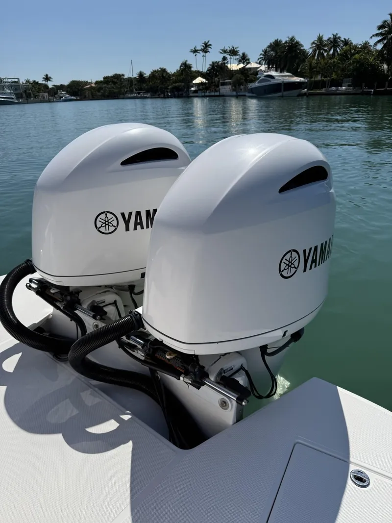 Slide: The Image of 2019 Regal 29 OBX with twin Yamaha outboard motors on a sunny waterfront. - 15