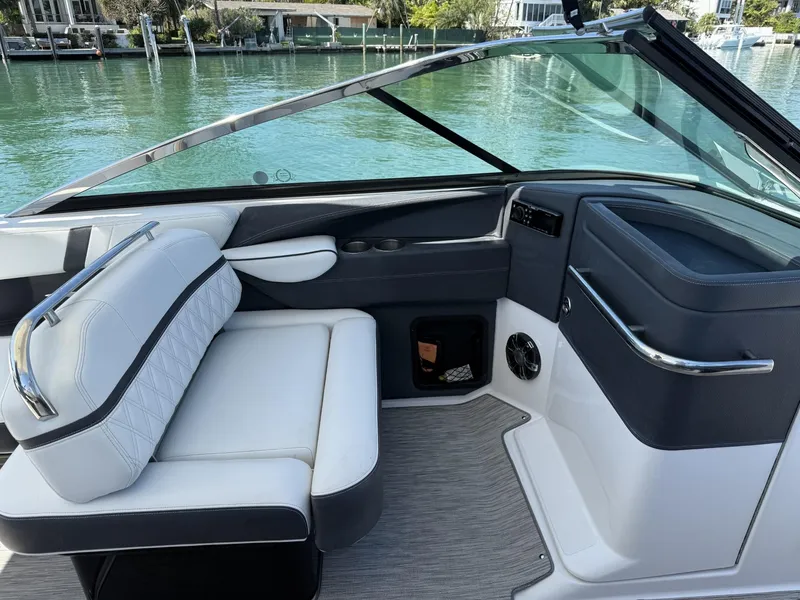 Slide: The Image of 2019 Regal 29 OBX boat interior with white seating and sleek dashboard design. - 19