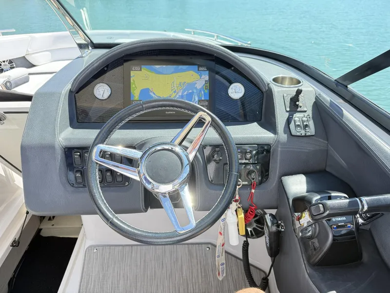 Slide: The Image of 2019 Regal 29 OBX boat dashboard with steering wheel and navigation display. - 24