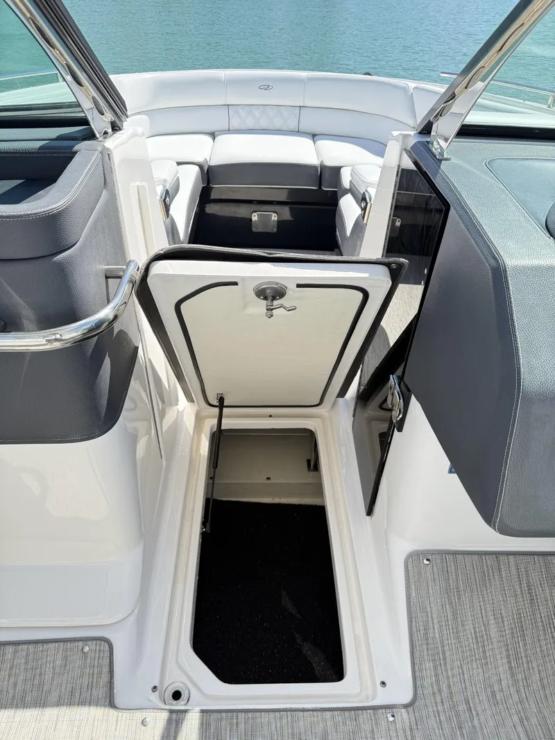Slide: The Image of 2019 Regal 29 OBX boat interior with open storage compartment and seating area. - 26