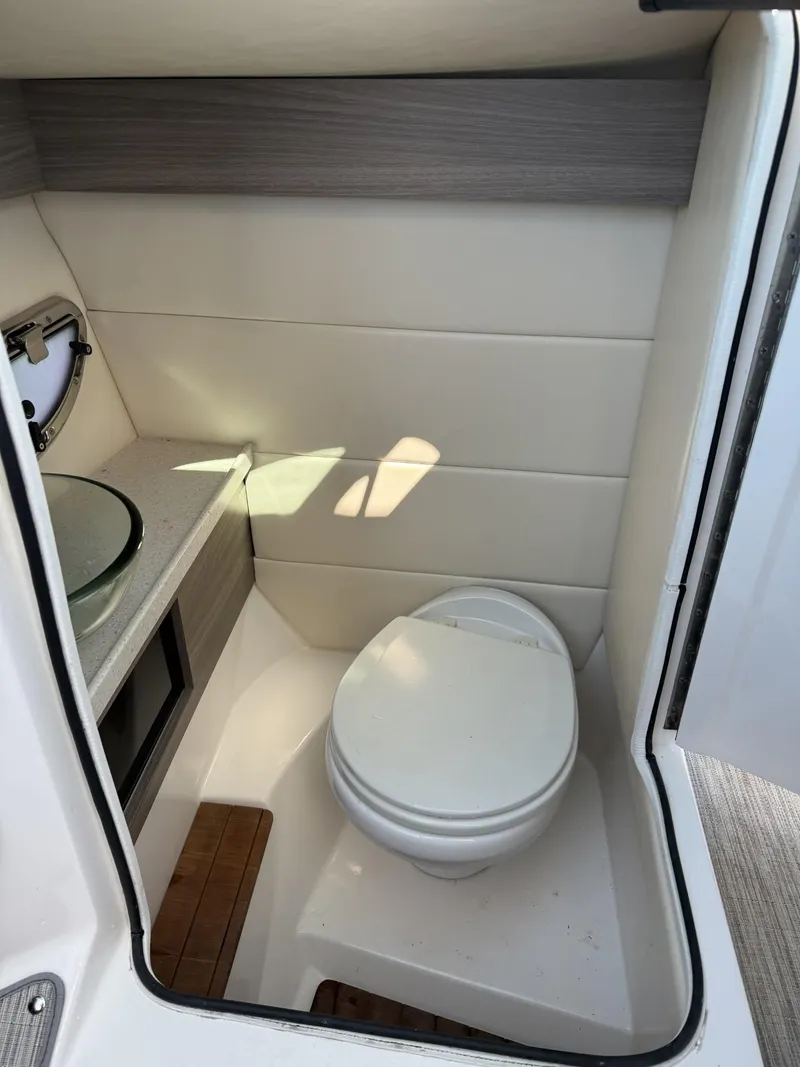 Slide: The Image of 2019 Regal 29 OBX boat interior bathroom with modern design and compact toilet. - 29