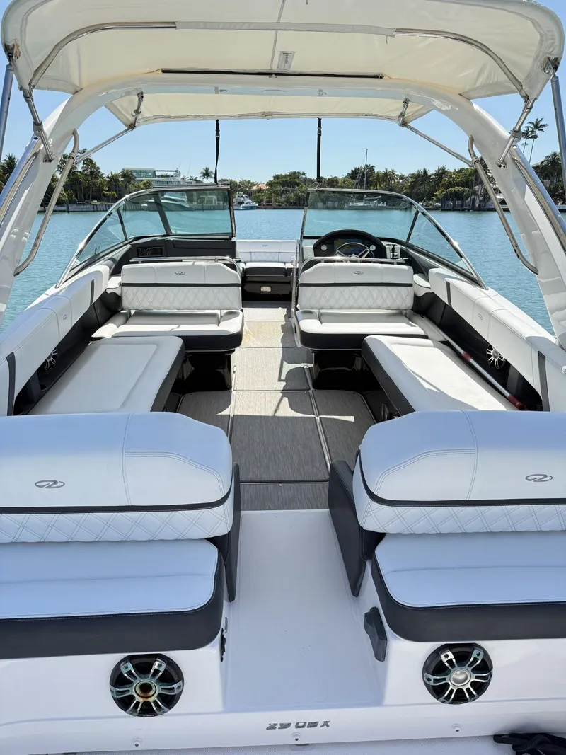 Slide: The Image of 2019 Regal 29 OBX boat interior with spacious seating and modern design on a sunny day. - 30