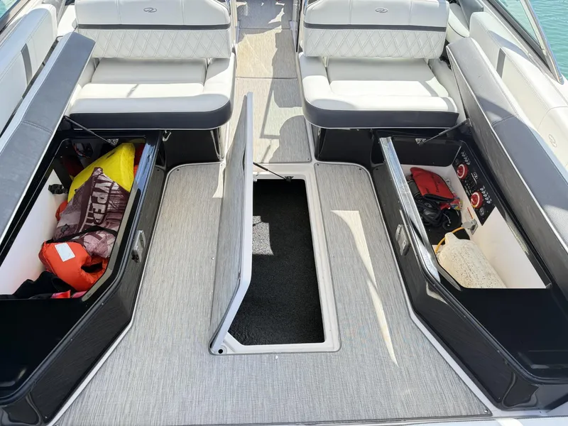 Slide: The Image of 2019 Regal 29 OBX boat interior with open storage compartments and seating. - 33