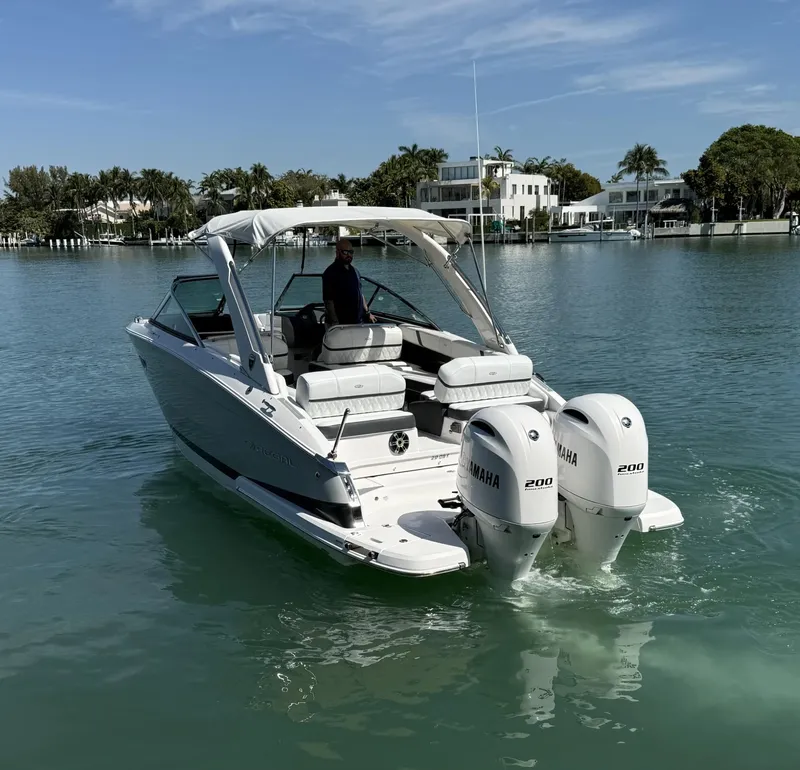 Slide: The Image of 2019 Regal 29 OBX boat with twin Yamaha engines on a calm waterway. - 9