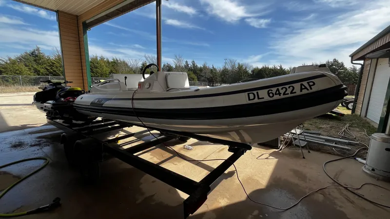 Slide: The Image of 2021 AB Inflatables ABJET 430XP on trailer under a covered area. - 12