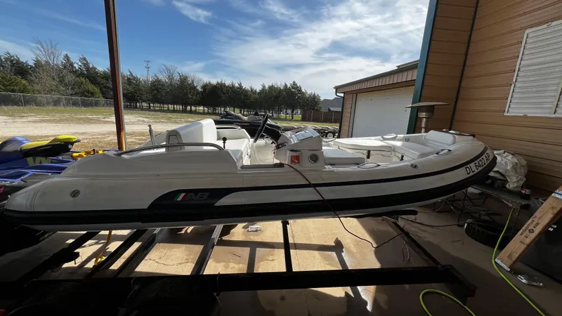 Slide: The Image of 2021 AB Inflatables ABJET 430XP boat on trailer, parked outdoors under clear sky. - 13