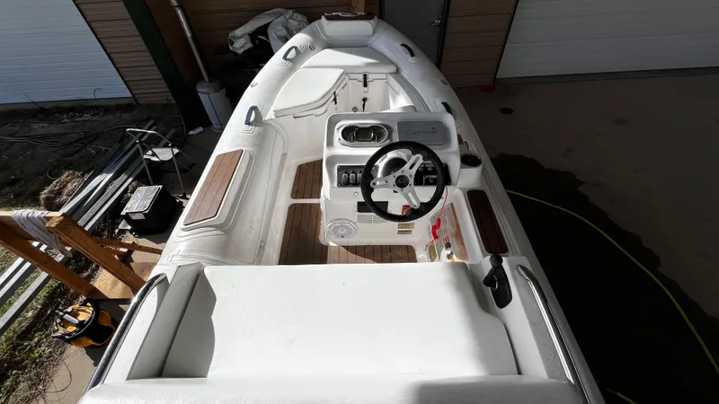 Slide: The Image of 2021 AB Inflatables ABJET 430XP boat interior with steering wheel and seating. - 8