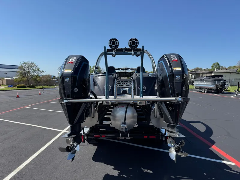 Slide: The Image of 2024 South Bay 25 Sport RS9-DC boat with dual outboard motors, rear view. - 3