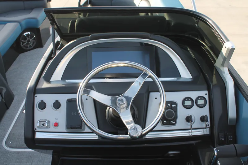Slide: The Image of 2024 South Bay 25 Sport RS9-DC boat dashboard with steering wheel and control panel. - 4