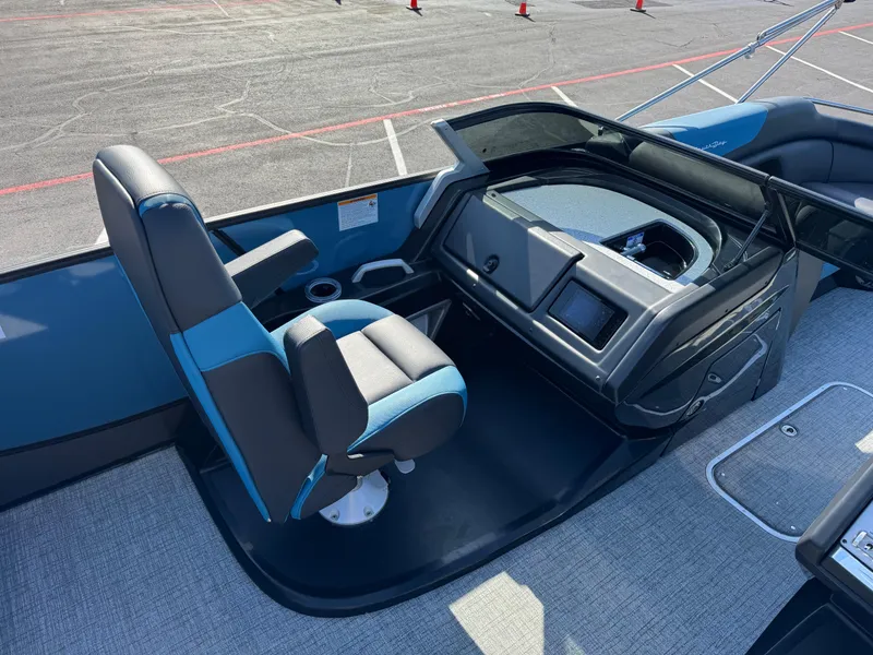 Slide: The Image of 2024 South Bay 25 Sport RS9-DC boat interior with captain's chair and control panel. - 8