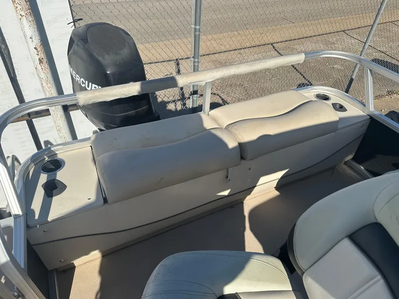 Slide: The Image of 2012 Sun Tracker Fishin' Barge 24 DLX interior with seating and Mercury outboard motor. - 11