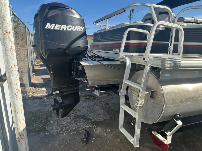 Slide: The Image of 2012 Sun Tracker Fishin' Barge 24 DLX with Mercury outboard motor and ladder. - 3