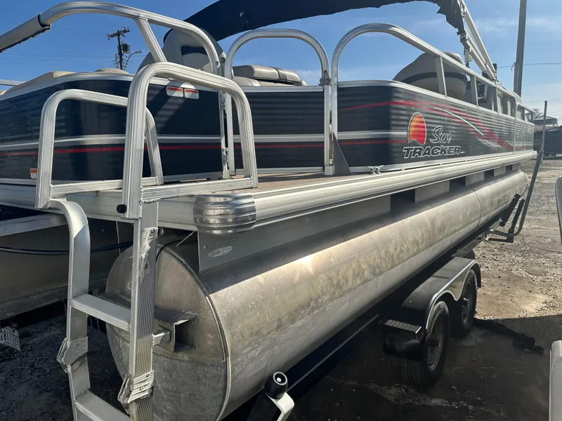 Slide: The Image of 2012 Sun Tracker Fishin' Barge 24 DLX pontoon boat on trailer, side view. - 4