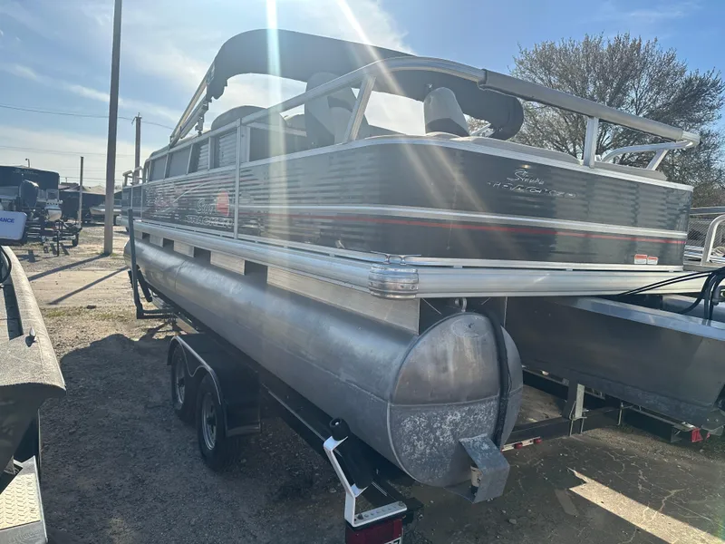Slide: The Image of 2012 Sun Tracker Fishin' Barge 24 DLX pontoon boat on trailer, outdoor setting. - 5