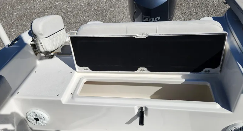 Slide: The Image of 2021 Sea Fox 248 Commander boat interior with open storage compartment and Yamaha 300 engine. - 17