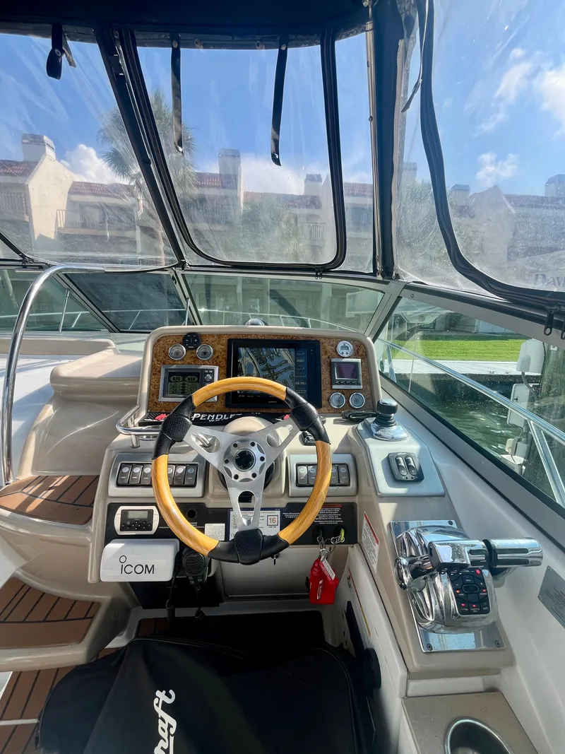 Slide: The Image of 2012 Formula 31 PC boat cockpit with steering wheel and navigation controls. - 10