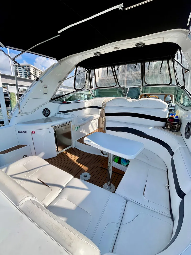 Slide: The Image of 2012 Formula 31 PC yacht interior with white seating and table, docked at marina. - 14