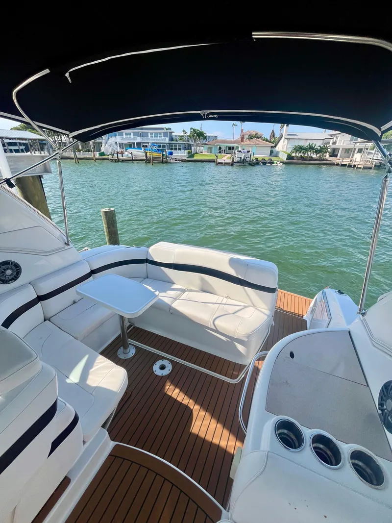 Slide: The Image of 2012 Formula 31 PC yacht interior with white seating, wooden deck, and waterfront view. - 15