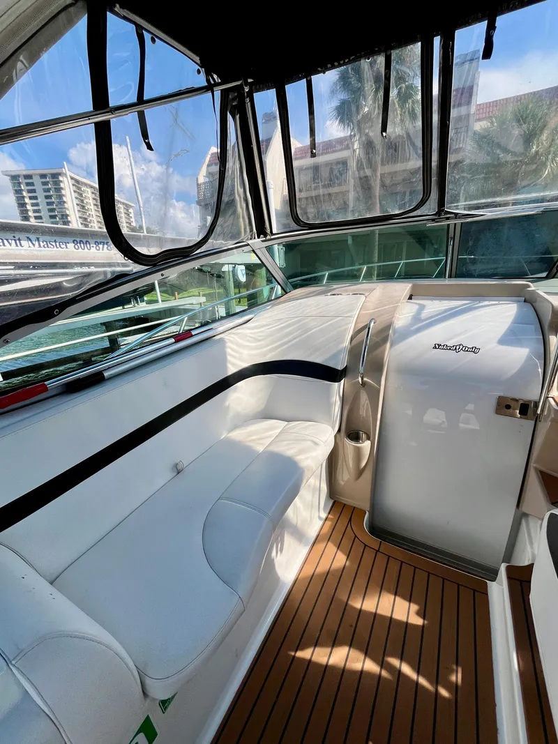 Slide: The Image of 2012 Formula 31 PC boat interior with white seating and wood flooring. - 18