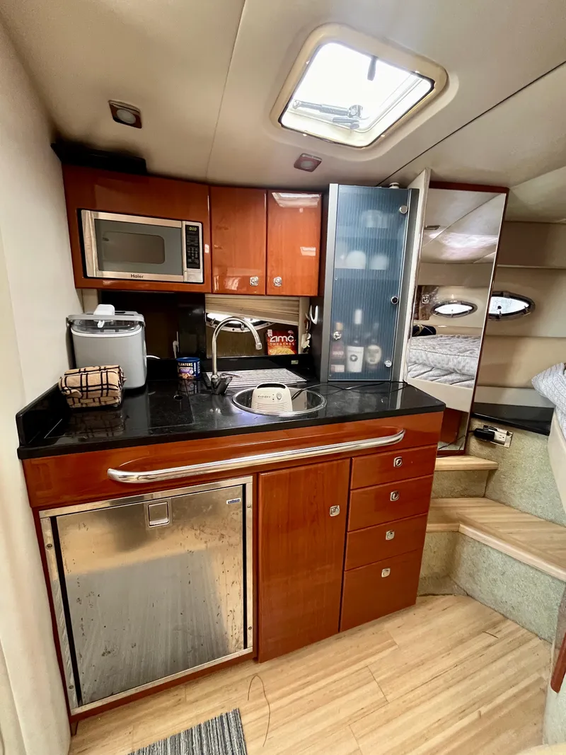 Slide: The Image of 2012 Formula 31 PC yacht interior kitchen with modern appliances and wooden cabinetry. - 24
