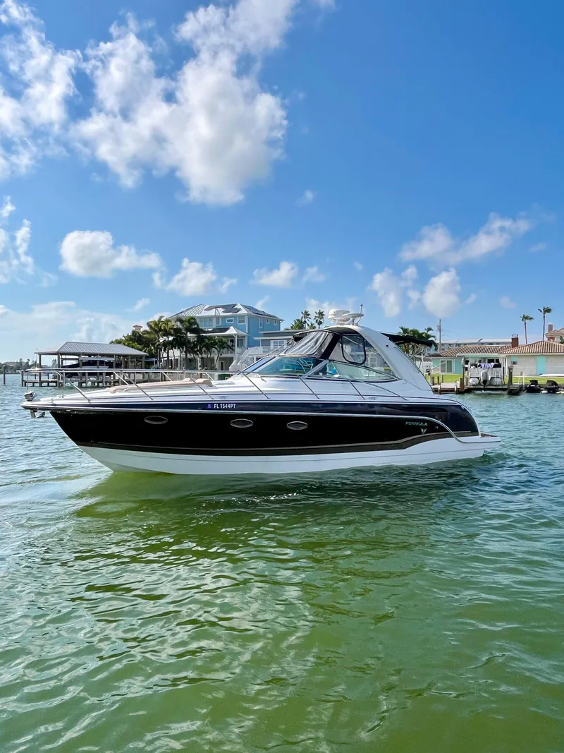 Slide: The Image of 2012 Formula 31 PC boat cruising on a sunny day in a marina. - 7