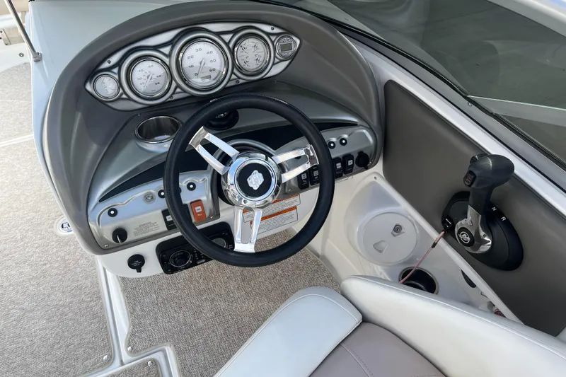 Slide: The Image of Steering console of a 2013 Azure AZ238 boat with gauges and controls. - 10