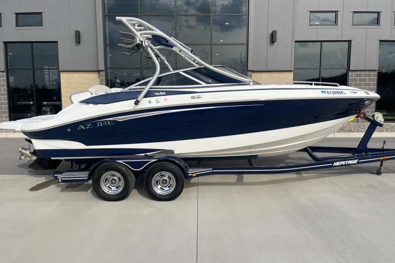Slide: The Image of Azure AZ238 boat on trailer, 2013 model, parked outside a modern building. - 2