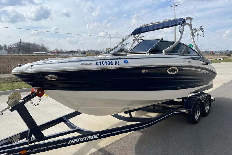 Slide: The Image of Azure AZ238 boat on trailer, 2013 model, parked outdoors under cloudy sky. - 4