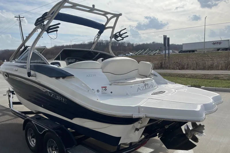 Slide: The Image of 2013 Azure AZ238 boat on trailer, sleek design, white and blue color scheme. - 6