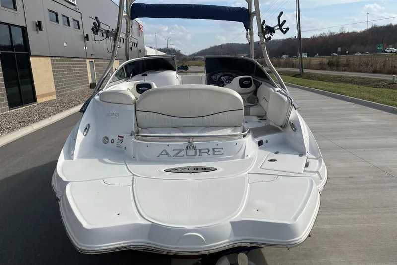 Slide: The Image of 2013 Azure AZ238 boat, rear view, parked on concrete near a building and road. - 8