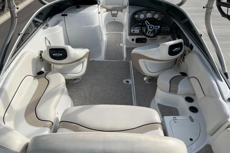 Slide: The Image of Interior of a 2013 Azure AZ238 boat with beige seating and modern dashboard. - 9