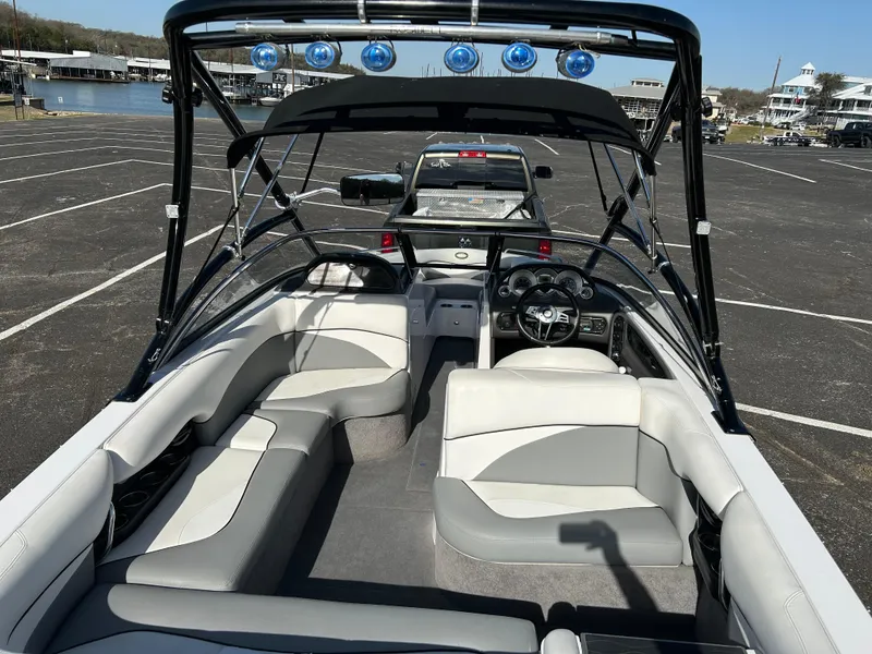 Slide: The Image of 2007 Supra Sunsport 22 V boat on trailer, parked in sunny lot with clear sky. - 3