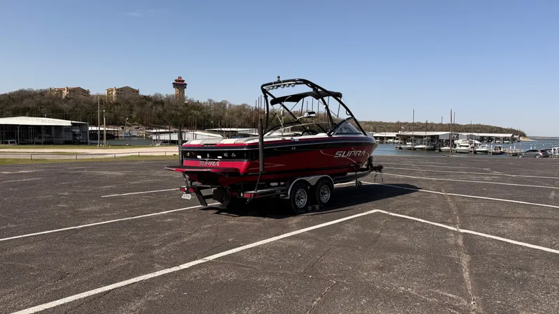 Slide: The Image of 2007 Supra Sunsport 22 V boat on trailer in parking lot near marina. - 5